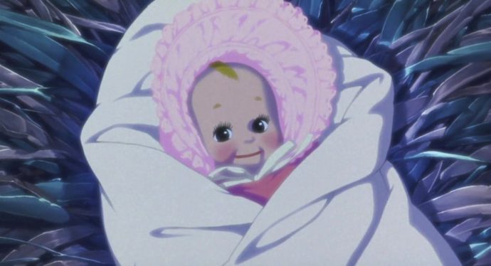Uma boneca enrolada em uma manta em uma manjedoura. 